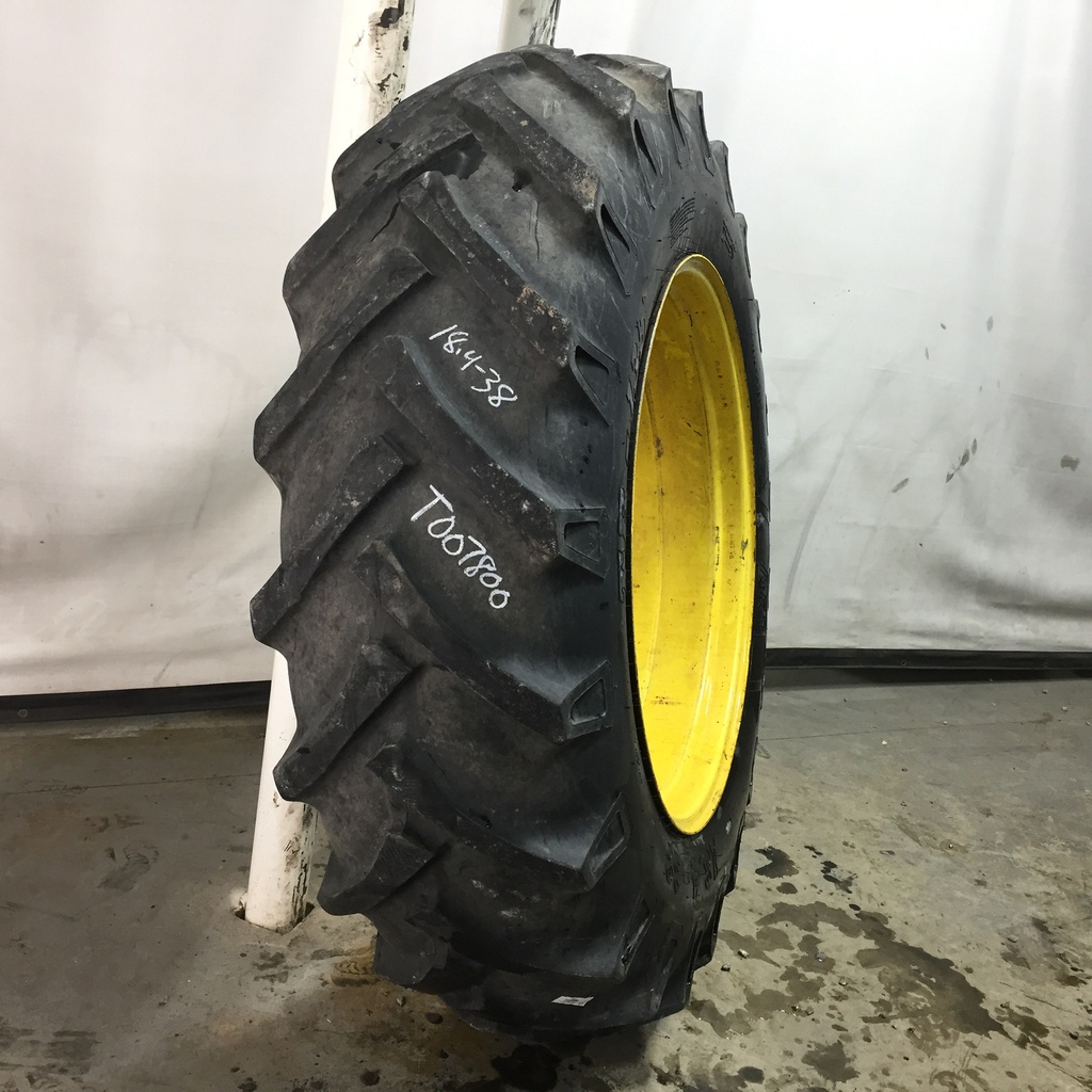18.4/-38 BKT Tires TR 135 Drive R-1 on John Deere Yellow 12-Hole Stub Disc 60%