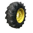 16.9/-26 BKT Tires TR 135 Drive R-1 on John Deere Yellow 10-Hole Waffle Wheel (Groups of 2 bolts) 30%