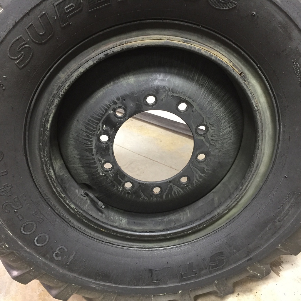 13.00/-24 Specialty Tires of America(STA) Superlug E-2/G-2 on Black 10-Hole OTR Wheel/3-piece 80%